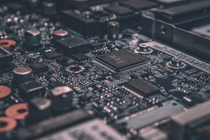 Close-up of an electronics circuit board on a repair bench