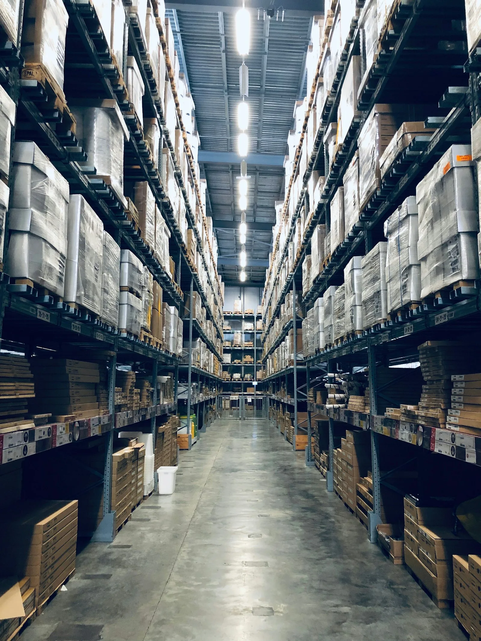Tall warehouse aisle with stocked shelves